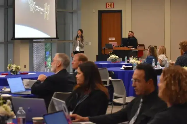 Speaker presenting to audience at conference event
